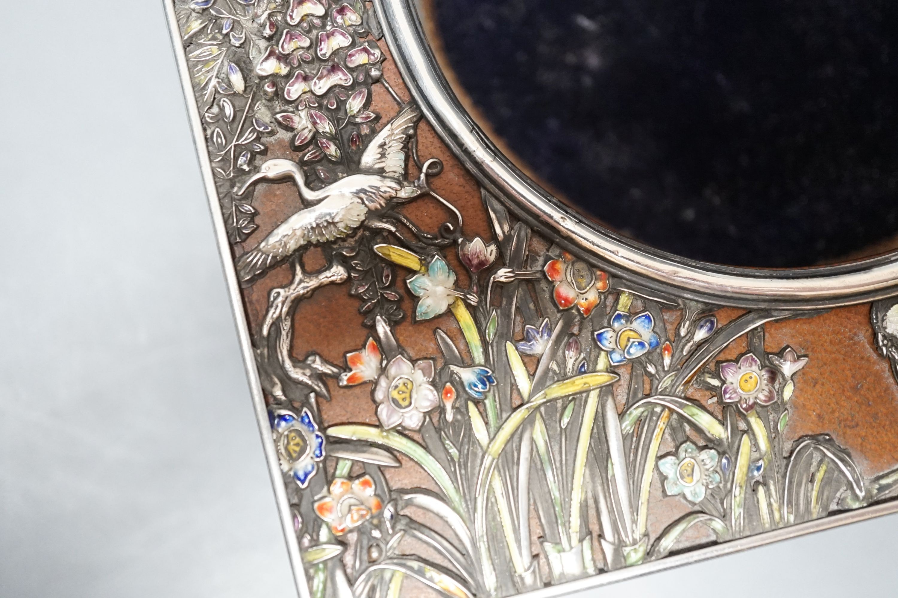 An early 20th century Japanese? white metal and polychrome enamel mounted leather travelling watch case, decorated with flowers and birds, 16.2cm.